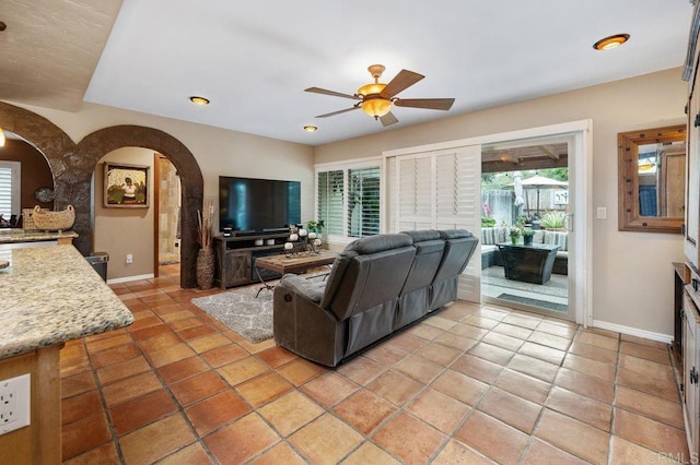 1663 Linda Sue Ln, Encinitas, CA 92024 - living room with arched walkways, ceiling fan, healthy amount of natural light, and light tile patterned floors