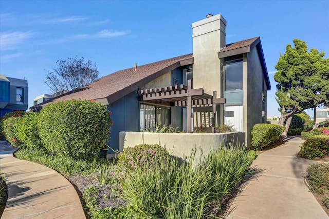6363 Rancho Mission Rd Unit 4, San Diego, CA 92108 - view of property exterior with a chimney and a shingled roof