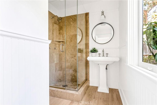 432 Holly St, Laguna Beach, CA 92651 - bathroom featuring a shower stall, wainscoting, wood finished floors, and a decorative wall