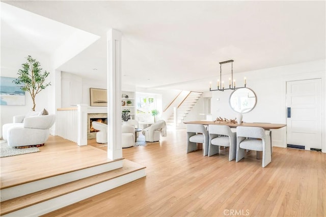 432 Holly St, Laguna Beach, CA 92651 - living room featuring stairway, light wood-style floors, and a warm lit fireplace