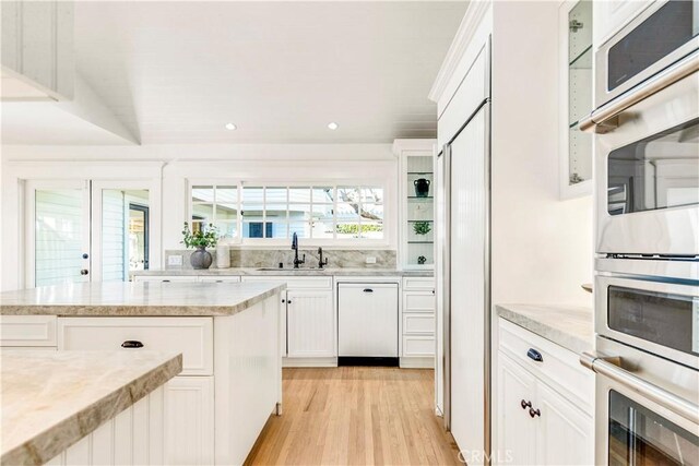 432 Holly St, Laguna Beach, CA 92651 - kitchen with a sink, white cabinetry, light wood-style flooring, white dishwasher, and recessed lighting