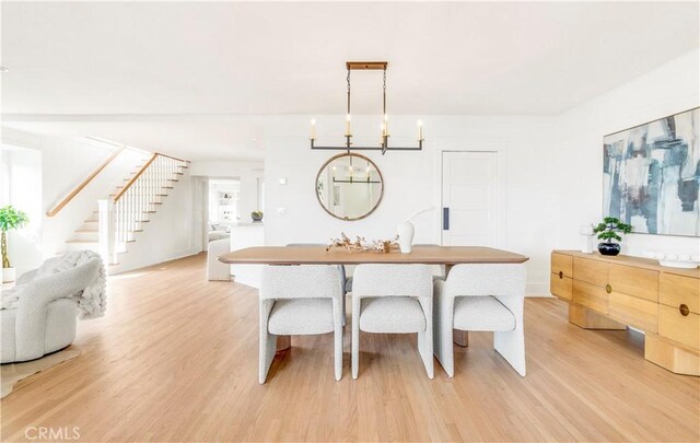 432 Holly St, Laguna Beach, CA 92651 - dining area with light wood-style floors, stairway, and a chandelier