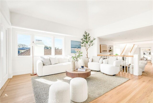 432 Holly St, Laguna Beach, CA 92651 - living room featuring light wood-type flooring, stairs, and baseboards