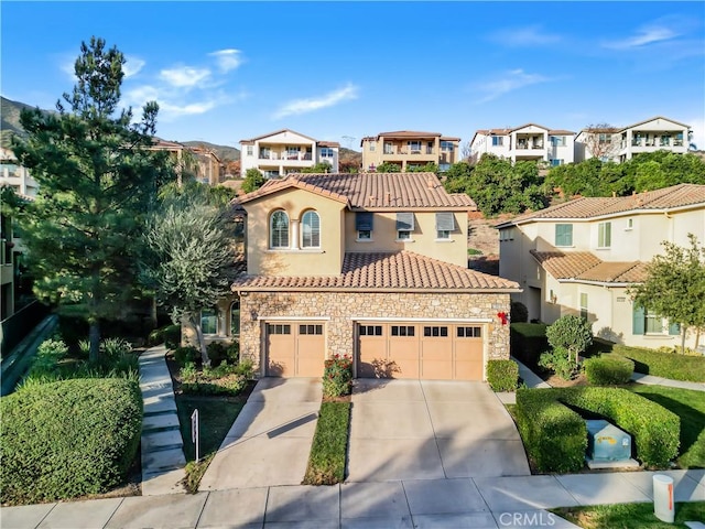 23795 Los Pinos Ct, Corona, CA 92883 - mediterranean / spanish-style home featuring stone siding, a residential view, concrete driveway, and a tiled roof