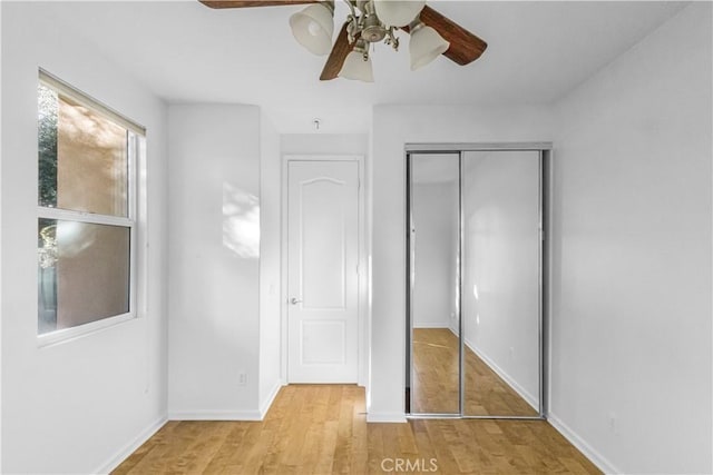 23795 Los Pinos Ct, Corona, CA 92883 - unfurnished bedroom featuring light wood-type flooring, a closet, baseboards, and a ceiling fan