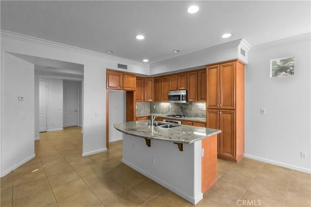 23795 Los Pinos Ct, Corona, CA 92883 - kitchen featuring stainless steel microwave, ornamental molding, a sink, light stone counters, and decorative backsplash