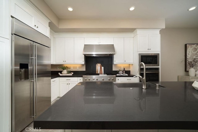 109 Pitch, Irvine, CA 92618 - kitchen featuring built in appliances, under cabinet range hood, dark countertops, white cabinetry, and recessed lighting