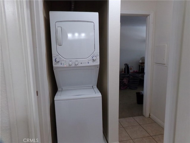 1598 Border Ave Unit H, Corona, CA 92882 - washroom featuring stacked washer and clothes dryer and light tile patterned floors