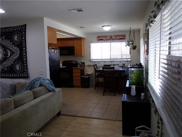 1598 Border Ave Unit H, Corona, CA 92882 - kitchen featuring black appliances, open floor plan, and light wood finished floors