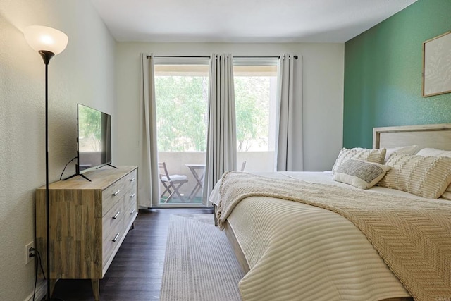 3171 Dehesa Rd Unit 3, El Cajon, CA 92019 - bedroom with dark wood-style flooring, access to outside, and a textured wall