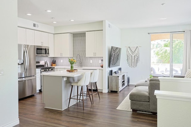 3171 Dehesa Rd Unit 3, El Cajon, CA 92019 - kitchen with appliances with stainless steel finishes, tasteful backsplash, a breakfast bar area, light countertops, and white cabinetry