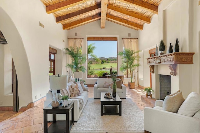 3198 Ashley Park Way, Jamul, CA 91935 - living area with high vaulted ceiling, wood ceiling with exposed beams, a fireplace with raised hearth, arched walkways, and baseboards