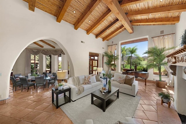 3198 Ashley Park Way, Jamul, CA 91935 - living area featuring arched walkways, wooden ceiling with exposed beams, plenty of natural light, high vaulted ceiling, and baseboards