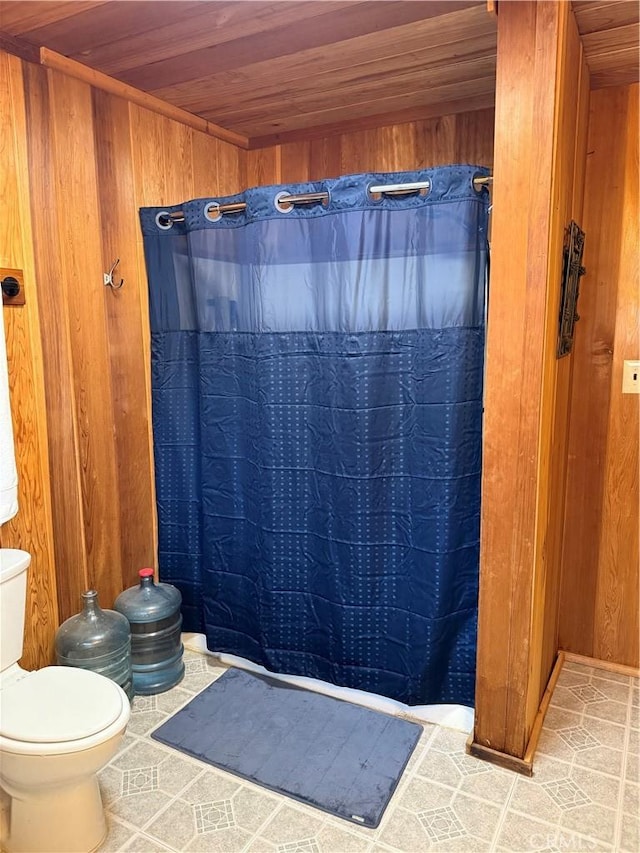 98011 Maine Rd, Kennedy Meadows, CA 93527 - full bath featuring wood ceiling, wood walls, toilet, curtained shower, and tile patterned floors