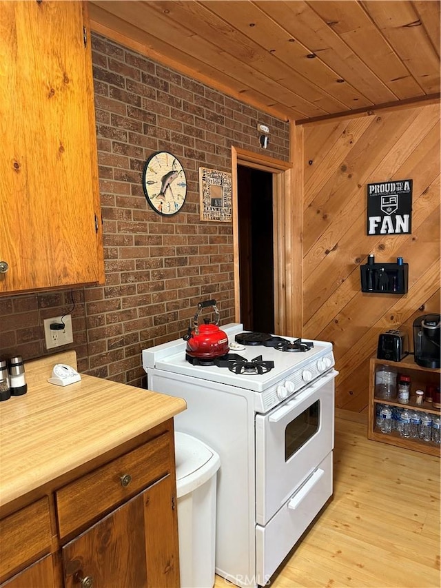 98011 Maine Rd, Kennedy Meadows, CA 93527 - kitchen featuring gas range gas stove, wood ceiling, light wood-style flooring, brown cabinets, and butcher block countertops