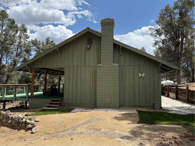 98011 Maine Rd, Kennedy Meadows, CA 93527 - view of home's exterior with board and batten siding and a chimney