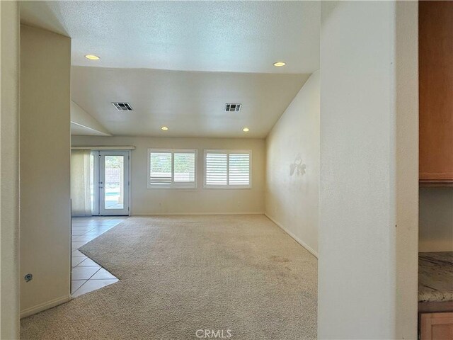 8520 Bolero Dr, Yucca Valley, CA 92284 - unfurnished room with carpet, recessed lighting, tile patterned flooring, baseboards, and a textured ceiling