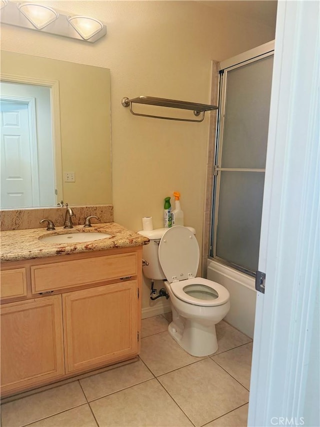 8520 Bolero Dr, Yucca Valley, CA 92284 - full bathroom featuring vanity, tile patterned floors, toilet, and combined bath / shower with glass door