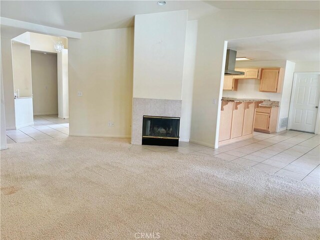 8520 Bolero Dr, Yucca Valley, CA 92284 - unfurnished living room with light tile patterned floors, light colored carpet, baseboards, a fireplace, and lofted ceiling