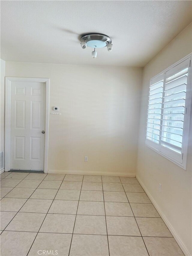 8520 Bolero Dr, Yucca Valley, CA 92284 - spare room with light tile patterned flooring and baseboards
