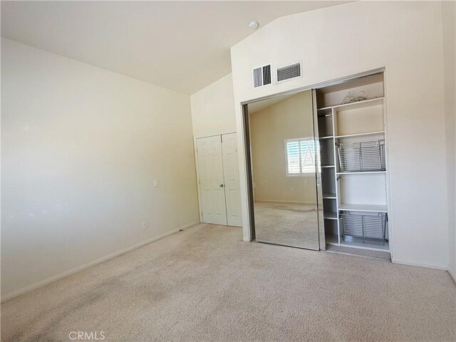 8520 Bolero Dr, Yucca Valley, CA 92284 - unfurnished bedroom with carpet flooring, a closet, high vaulted ceiling, and baseboards