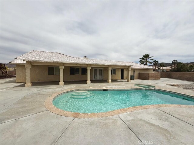 8520 Bolero Dr, Yucca Valley, CA 92284 - view of pool with a patio, french doors, and a pool with connected hot tub