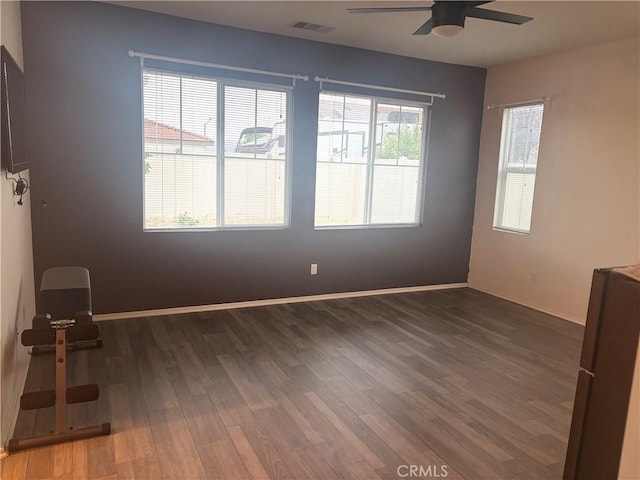 1884 Glow Pointe, San Jacinto, CA 92582 - empty room with a ceiling fan, wood finished floors, and baseboards