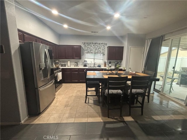 1884 Glow Pointe, San Jacinto, CA 92582 - kitchen with stainless steel appliances, light countertops, plenty of natural light, dark brown cabinetry, and recessed lighting
