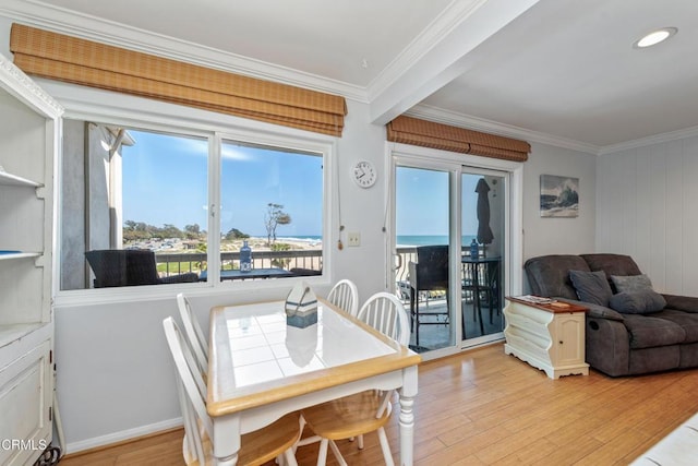 4975 Sandyland Rd Unit 302, Carpinteria, CA 93013 - dining space featuring crown molding, light wood-style floors, plenty of natural light, and baseboards