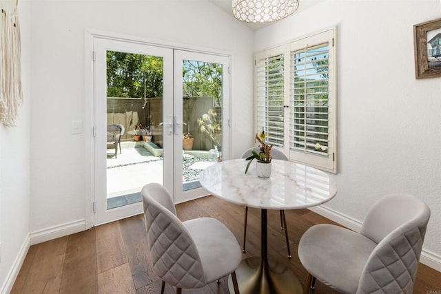 6848 Xana Way, Carlsbad, CA 92009 - dining area featuring french doors, baseboards, wood finished floors, and lofted ceiling