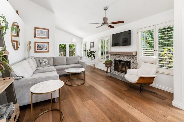 6848 Xana Way, Carlsbad, CA 92009 - living room with vaulted ceiling, a ceiling fan, wood finished floors, baseboards, and a fireplace