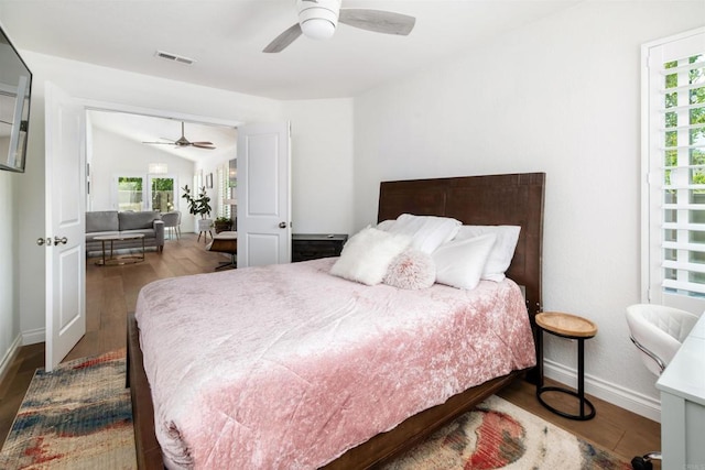 6848 Xana Way, Carlsbad, CA 92009 - bedroom with wood finished floors, baseboards, vaulted ceiling, and ceiling fan