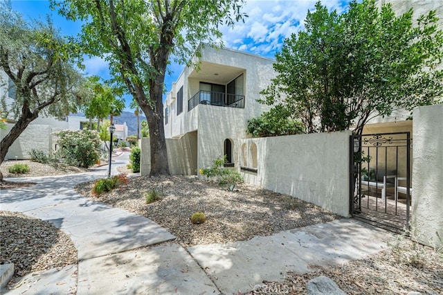 45405 Lupine Ln Unit 16, Palm Desert, CA 92260 - view of front of house featuring a balcony, stucco siding, and a gate