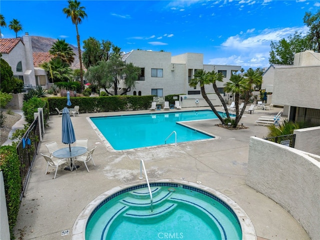 45405 Lupine Ln Unit 16, Palm Desert, CA 92260 - community pool featuring a hot tub, a patio, and a residential view