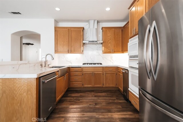 1171 Otano Way, Oxnard, CA 93030 - kitchen featuring stainless steel appliances, wall chimney exhaust hood, a sink, a peninsula, and dark wood-style floors