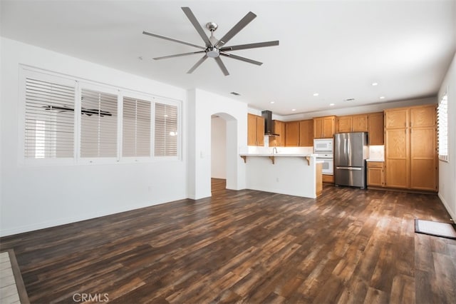 1171 Otano Way, Oxnard, CA 93030 - unfurnished living room featuring dark wood-style flooring, arched walkways, ceiling fan, and recessed lighting