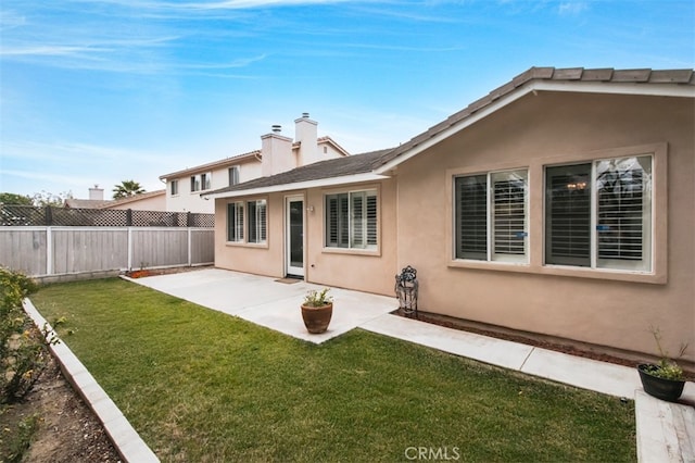 1171 Otano Way, Oxnard, CA 93030 - back of property featuring stucco siding, a patio area, and a chimney