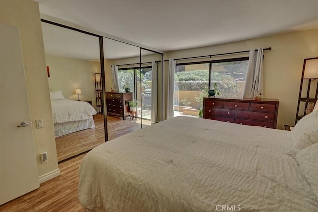 25712 Le Parc Unit 7, Lake Forest, CA 92630 - bedroom with wood finished floors, access to outside, and baseboards