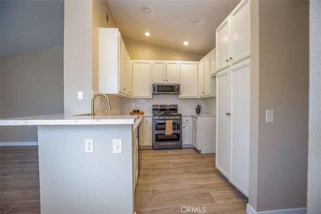 369 Chaumont Cir, Lake Forest, CA 92610 - kitchen with stainless steel appliances, a peninsula, tasteful backsplash, light wood-type flooring, and light countertops