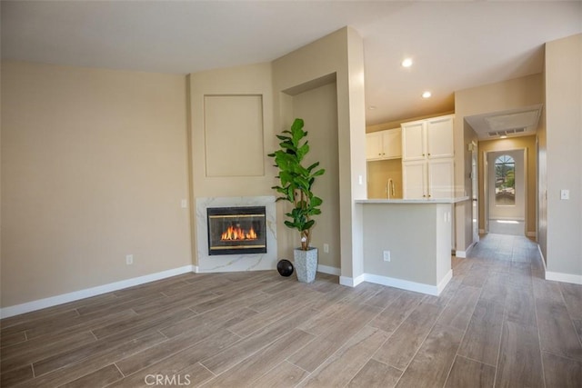 369 Chaumont Cir, Lake Forest, CA 92610 - unfurnished living room with wood finished floors, a high end fireplace, and recessed lighting