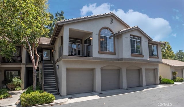 369 Chaumont Cir, Lake Forest, CA 92610 - view of front facade with stairs, stucco siding, an attached garage, and a tiled roof