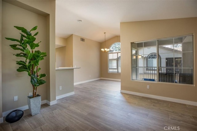 369 Chaumont Cir, Lake Forest, CA 92610 - unfurnished room featuring a chandelier, lofted ceiling, and wood finished floors