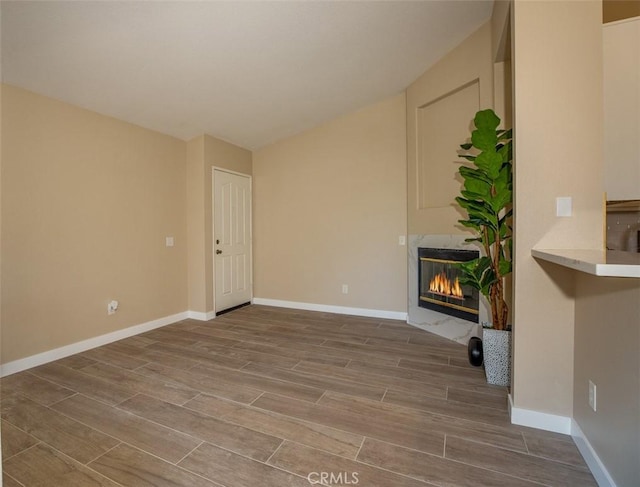 369 Chaumont Cir, Lake Forest, CA 92610 - unfurnished living room featuring wood finished floors, a glass covered fireplace, and lofted ceiling