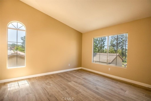 369 Chaumont Cir, Lake Forest, CA 92610 - unfurnished room with wood finished floors, healthy amount of natural light, and lofted ceiling