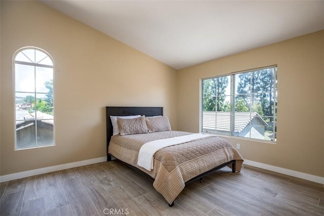 369 Chaumont Cir, Lake Forest, CA 92610 - bedroom featuring multiple windows, wood finished floors, and vaulted ceiling