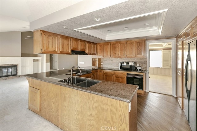 19355 Tomahawk Rd, Apple Valley, CA 92307 - kitchen with black appliances, a sink, a peninsula, crown molding, and a raised ceiling
