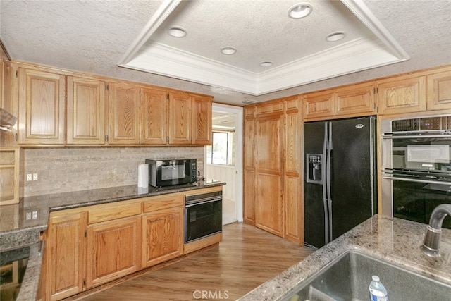 19355 Tomahawk Rd, Apple Valley, CA 92307 - kitchen featuring black appliances, a textured ceiling, ornamental molding, stone countertops, and light wood-type flooring