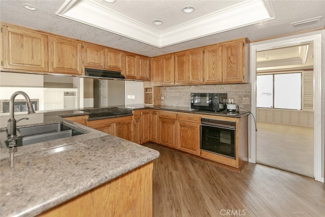 19355 Tomahawk Rd, Apple Valley, CA 92307 - kitchen with black appliances, a sink, ornamental molding, light wood finished floors, and light stone countertops