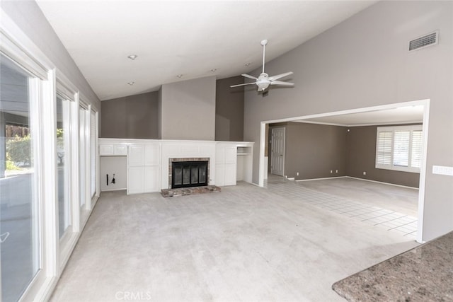 19355 Tomahawk Rd, Apple Valley, CA 92307 - unfurnished living room with light carpet, a ceiling fan, high vaulted ceiling, a brick fireplace, and baseboards