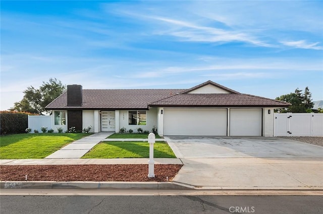 1563 Gary Ln, Redlands, CA 92374 - ranch-style house with driveway, a garage, a gate, a tiled roof, and french doors